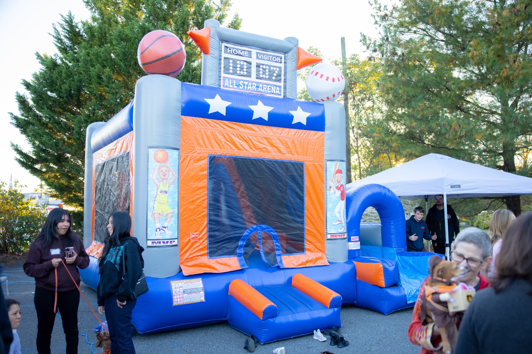 Families and pets gathered near the bounce house at SiRa's 2025 event